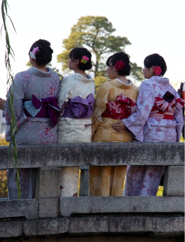 Geisha Girls sitting on bridge in Kurashiki