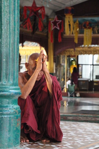 Monk praying in Yangong, Myanmar